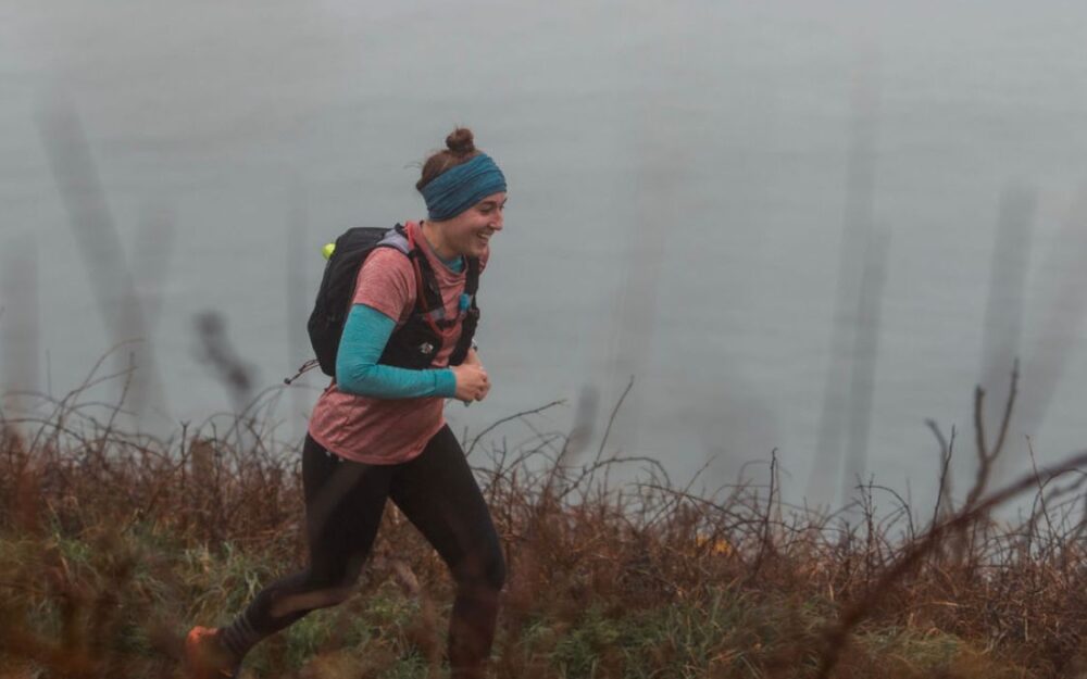 Woman running in front of the sea