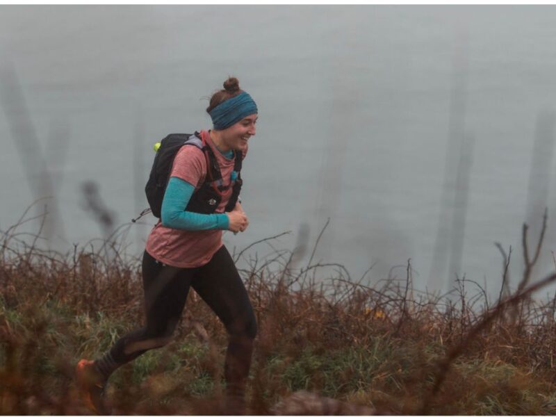 Woman running in front of the sea