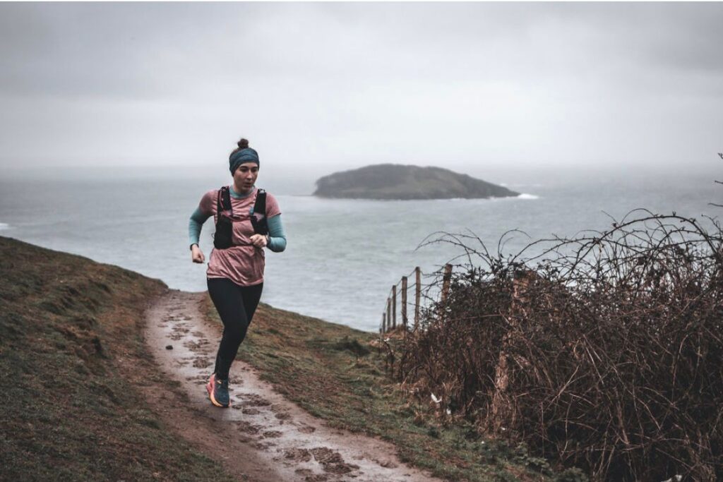 Woman running with sea in the background