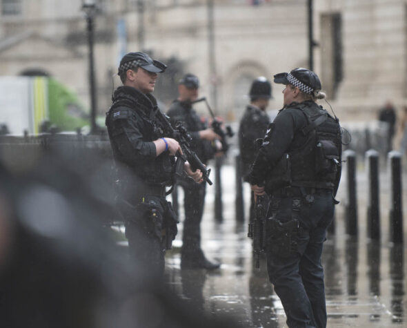 Two Ministry of Defence Police officers have a conversation outside